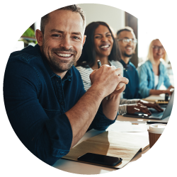 Diverse group of travel agents smiling that they are in the news for their hard work at Sky Bird Travel